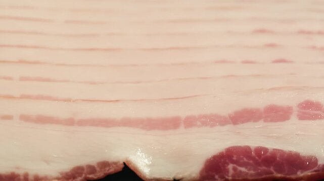  Sliced ham jamon fat bacon meat, beef pastrami thick pieces on a wooden board, beef or pork jamon. Chef cooking breakfast, smoked bacon in cafe. 