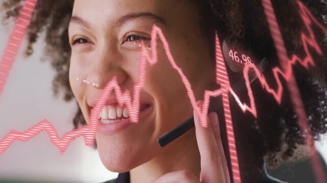 Sales agent speaking, touching headset, animating red-pink chart across face showing sales metrics