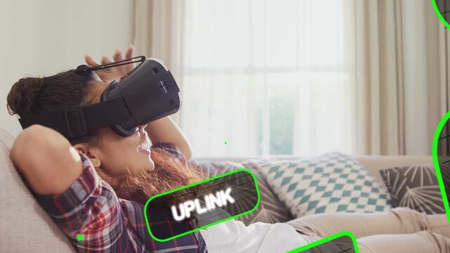 Woman on couch adjusting headset, activating green HUD tiles entering right, viewing network stream