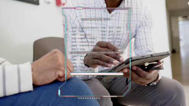 Male advisor opening tablet and guiding senior client through quantitative data overlay in clinic