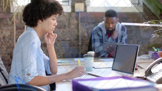 Woman writing with yellow pen at desk as man tapping tablet, causing animated list for marketing
