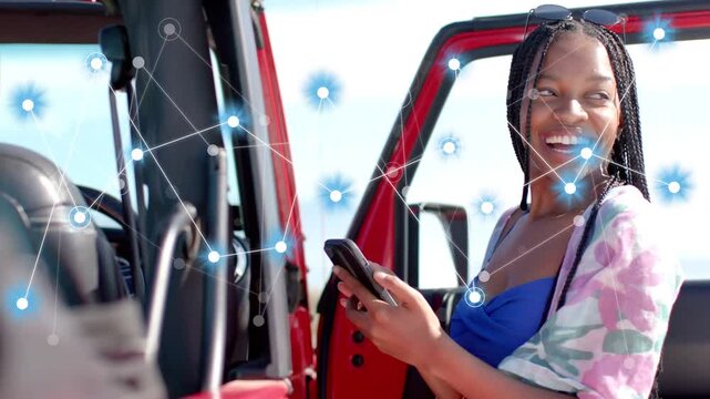 Woman by red SUV, scrolling smartphone starting blue-node tech overlay overlapping woman relaxing