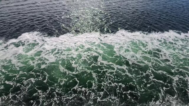 August 13, 2024 - Tracy Arm, USA - Water surface showing patterns of waves and boat motion created by a ship traveling through Tracy Arm fjord system in Alaska.