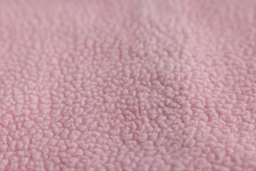 Macro texture of soft pink fleece or faux fur fabric © Ruslan