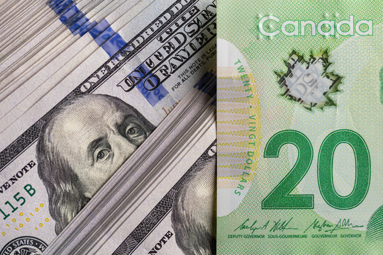 US hundred dollar bill and Canadian twenty dollar banknote close up