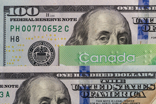 US hundred dollar bill and Canadian twenty dollar banknote close up