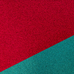 Fototapeta premium Colorful texture with red and green shades on a flat surface showing a split in colors during daylight
