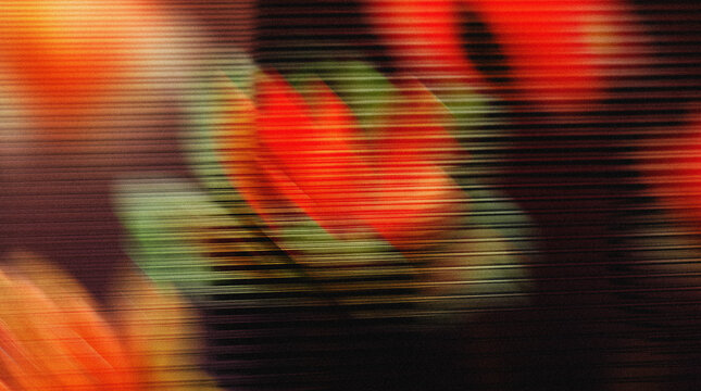 Floral motion blur featuring vibrant red and green hues with a soft focus effect, creating an abstract representation of flowers in a dark background setting