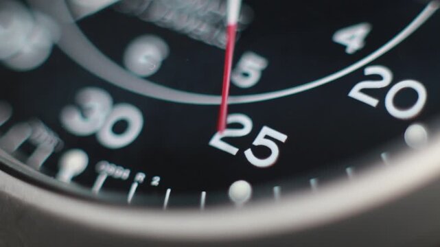 Macro close up of an automatic mechanical field watch with moving arms
