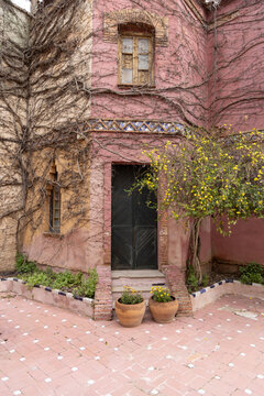 Courtyard with stone well and pink facade of the historic Casa del Campillo (Casa de los Martos), Ronda, Spain, Andalusia