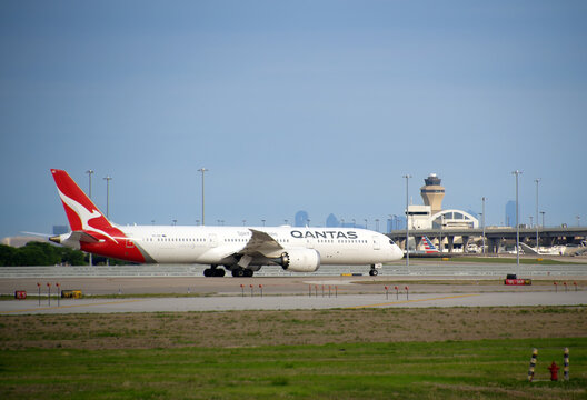 Qantas Airways aircraft Boeing 787-9 Dreamliner taking off from Dallas Fort Worth International Airport (DFW), blue skies.