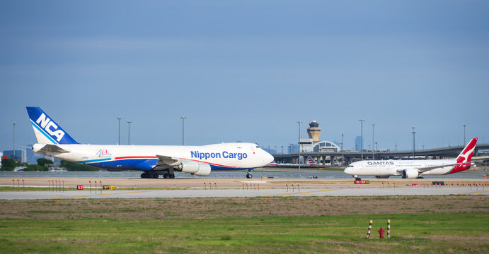 Nippon Cargo Airlines aircraft Boeing 747-8F and Qantas Airways Dreamliner at the Dallas Fort Worth International Airport (DFW). 