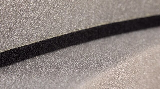 Grey foam background texture extreme close up with a rotating camera move stock footage