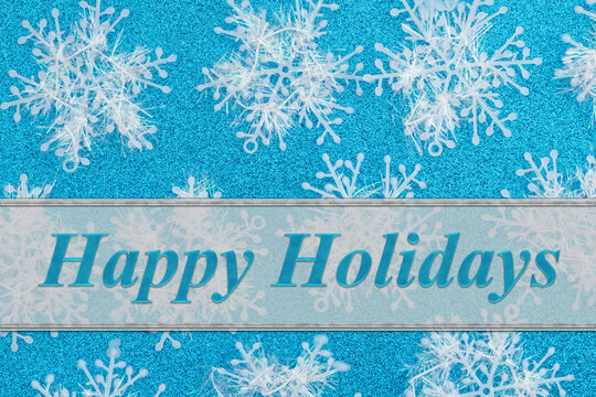 Happy holidays with snowflakes on blue