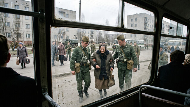 Soviet soldiers assisting an elderly woman during the Pripyat evacuation in 1986