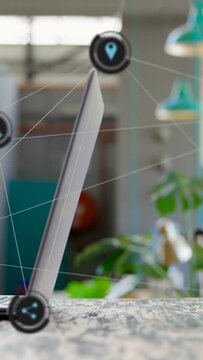 Vertical video: Left hand on laptop causing icons, phone entering, tapping phone clearing alerts