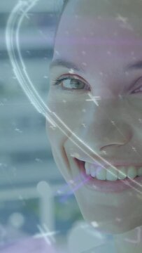 Woman turning to cam soft light nudging eyelids opening smiling tech FX adding streaks across face