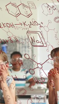 Vertical video: Pupils reacting to lab demo, fixing goggles observing reaction through red formulas