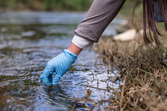 Environmental engineer checking water quality in river
