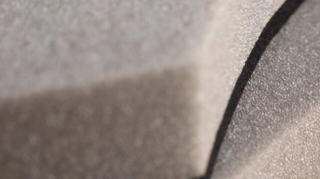 Grey foam background texture extreme close up with a rotating camera move stock footage