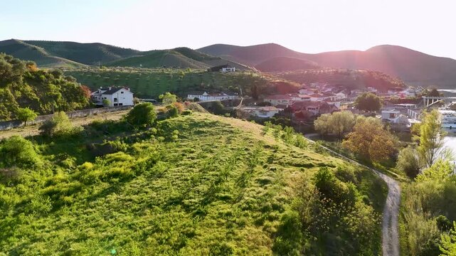 Drone flying over green hills revealing douro river valley landscape