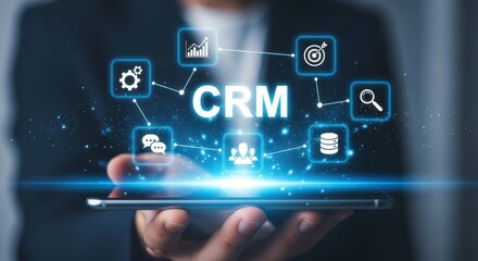 Fototapeta premium Business professional interacting with CRM interface on digital tablet with glowing icons