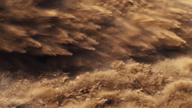 Massive flow of earth, rocks, and dust moving downward in a powerful and destructive landslide