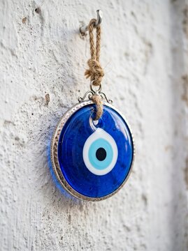 Blue Nazar evil eye amulet hanging on wall
