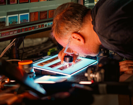 Photographer analog film negatives light table