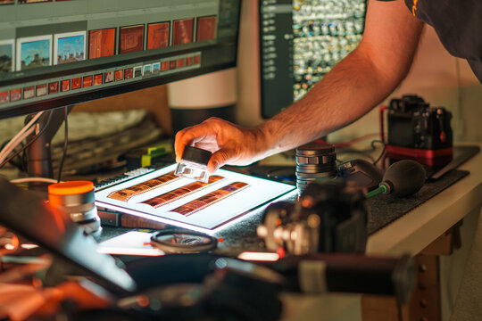 Photographer film strips loupe light table