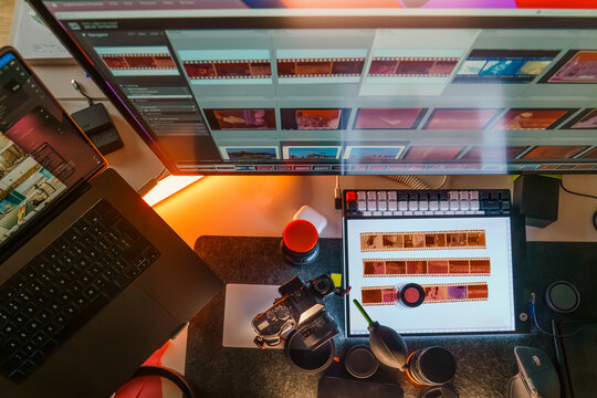Photographer workspace monitor lightroom software interface film strips light table