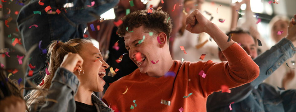Excited fans celebrating the win in live match at stadium.