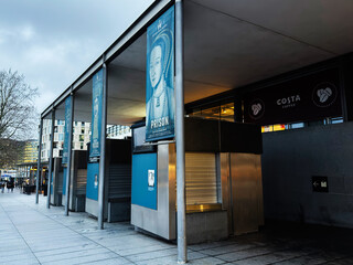 Naklejka premium Empty riverside kiosks and historical exhibition banners at riverside promenade in London UK with closed Costa Coffee and modern urban architecture