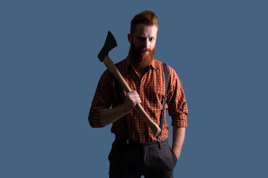 Brutal Caucasian hipster with retro moustache. Bearded man isolated on grey. Bearded man hold ax. Hair and beard care. Handsome bearded brutal man. Beard styling with axe