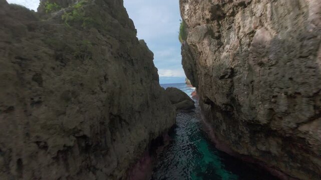 FPV Drone Flying Through Narrow Rock Canyon in Niue