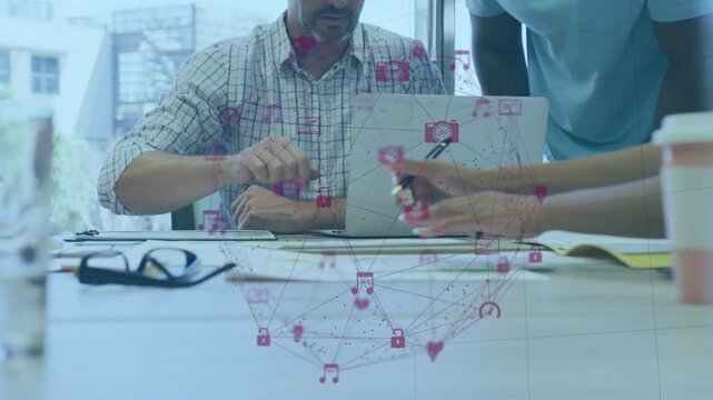 Seated mgr pointing at laptop, initiating pen pass, colleagues noting for business apps overlaying