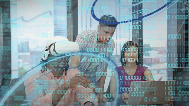 Team running tech demo at laptop, woman typing initiating binary HUD while VR user interacting