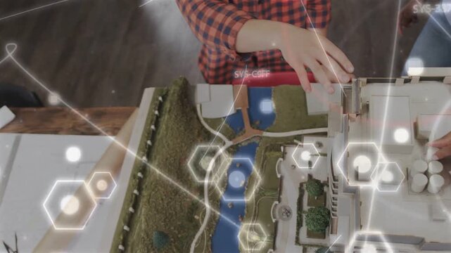 Checkered-shirt man and vested woman reaching, fitting rooftop parts for design review with AR hex