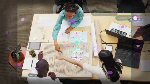 Top woman leaning and pointing, design team moving model parts and deciding plan, purple UI guiding