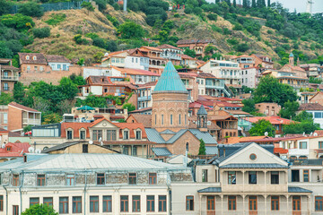 Tbilisi old town skyline with historic church and colorful houses on hillside, Georgia. Georgian landmark combining architecture, culture and urban landscape. Travel destination in Caucasus region © samael334