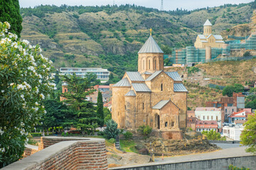 Metekhi Church in Tbilisi old town showing traditional Georgian stone architecture and domed structure. Historic religious landmark located above Kura River. Travel destination in Caucasus region © samael334
