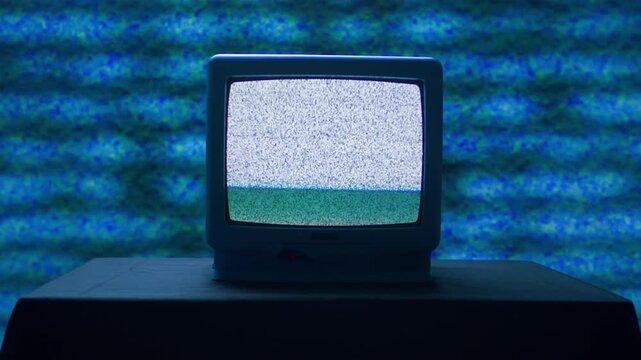 Retro TV, vintage television In a nostalgic setup, a retro TV displays grain on screen, scary halloween night device good for chroma key and green screen.