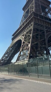 Magnified shot revealing detailed iron lattice of Eiffel Tower against sky