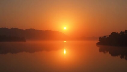 Obraz premium Golden Sunset Over Calm Lake with Reflections and Mountains.