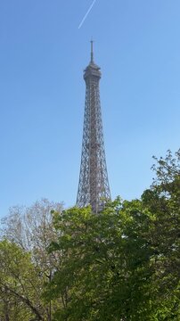 Eiffel tower treetop outlook skyline with airplane passage