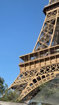 Structural elements of Eiffel tower against bright blue day sky