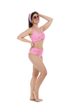 Woman in pink swimsuit and sunglasses on white background