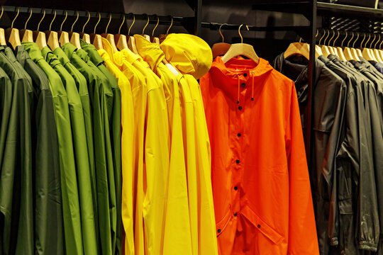 Colorful rain jackets displayed in a store for customers to browse and choose from in a shopping area