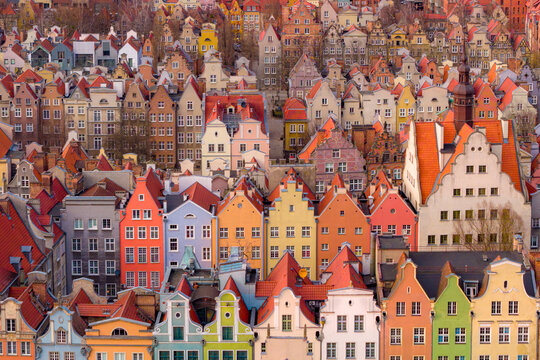 Aerial view of colorful historic townhouses with red rooftops and narrow facades in the old town of Gdansk, Pomeranian Voivodeship, Poland.