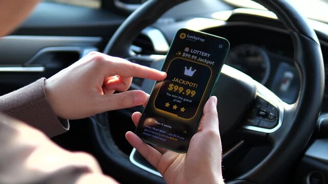 Man playing online slots on smartphone in car. Close up of hands tapping spin button in mobile gambling app interface. High quality POV shot of digital entertainment, casual gaming and mobile betting